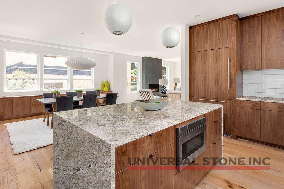 beautiful kitchen in new luxury home with island, pendant lights, and hardwood floors. Has view of Dining Room